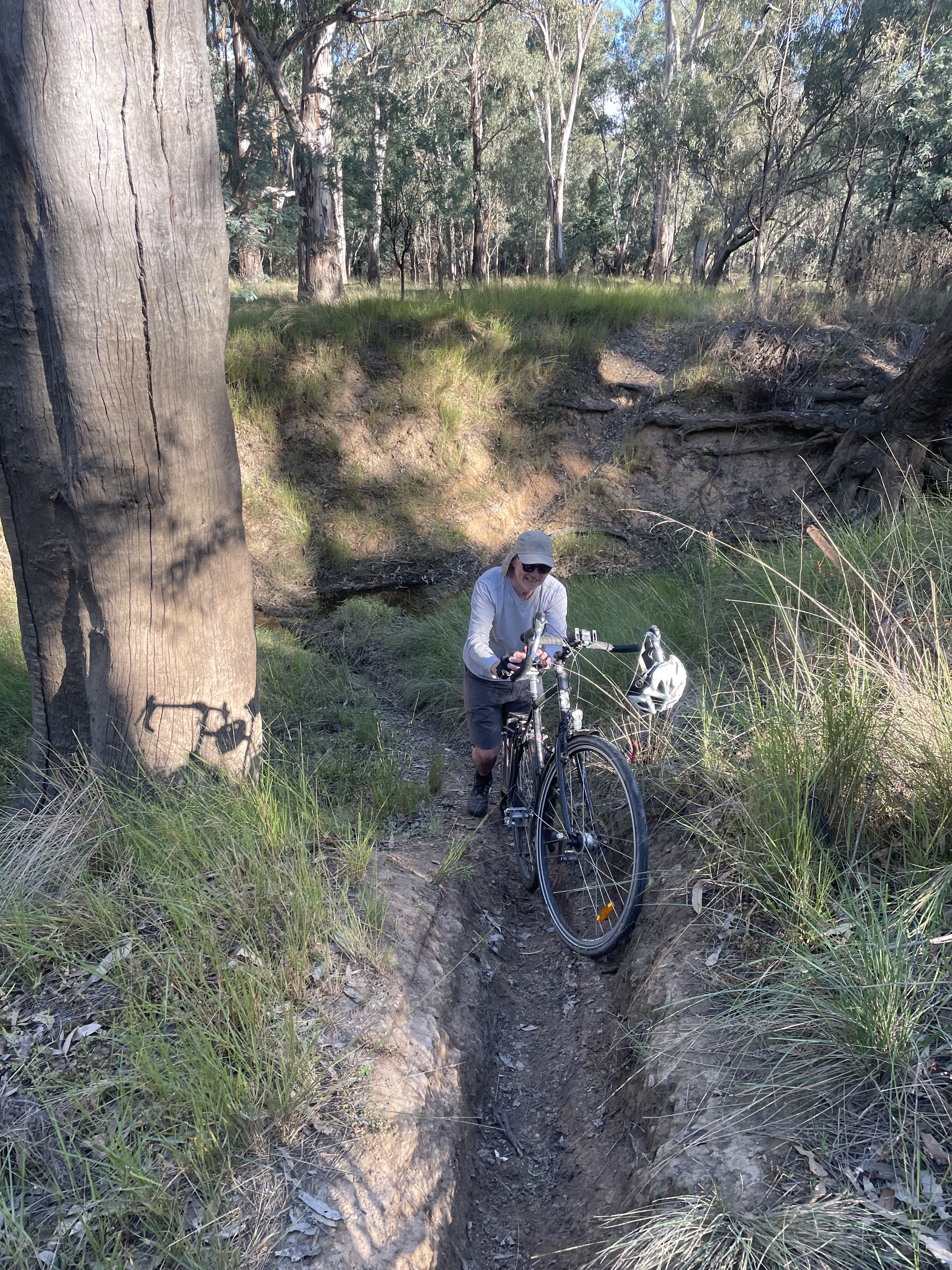 Porting our bikes through an unexpected gully